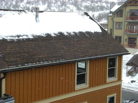 A roof heating system installed under shingles of a mountain resort structure.