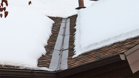 A roof heating system installed to heat valleys and roof eaves.