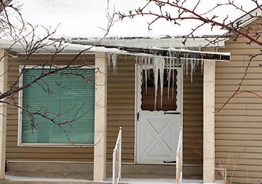 Snow and ice damage to a roof gutter.